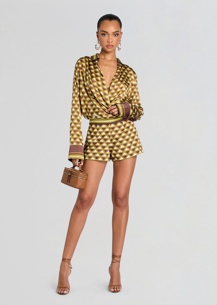 Woman wearing a patterned outfit with a plain background media 2 of 5