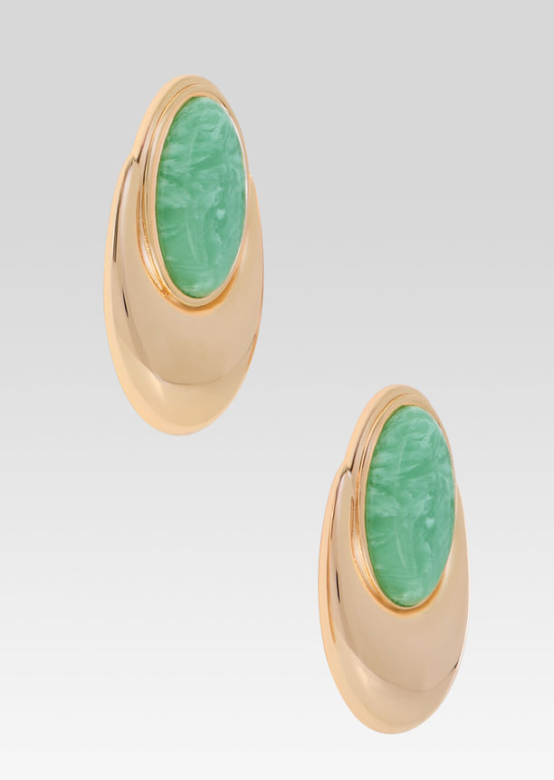 Gold earrings with large oval green stones set in smooth gold frames.