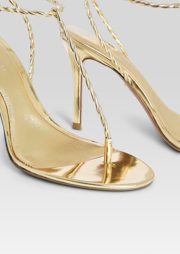Gold metallic Cleo sandal close up with braided rope straps and open toe