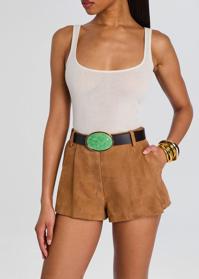 Model wearing a black Dagmar belt with a green oval buckle over tan suede shorts media 3 of 3