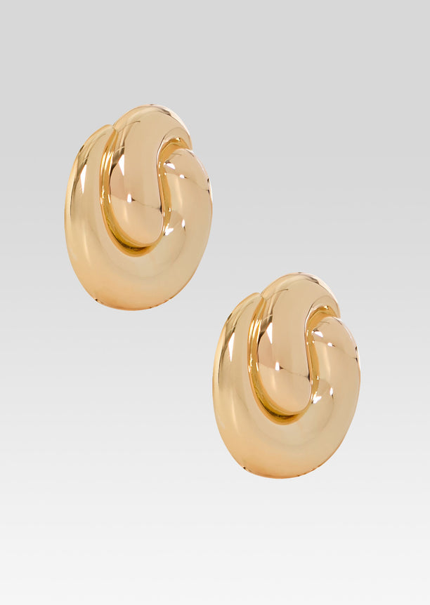 Pair of gold Doma earrings with oversized circular discs and a curved inner swirl