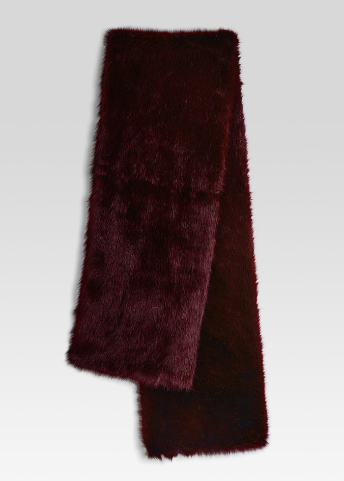 A dark burgundy faux fur scarf folded to show its plush texture, set against a light gray gradient background. media 1 of 3