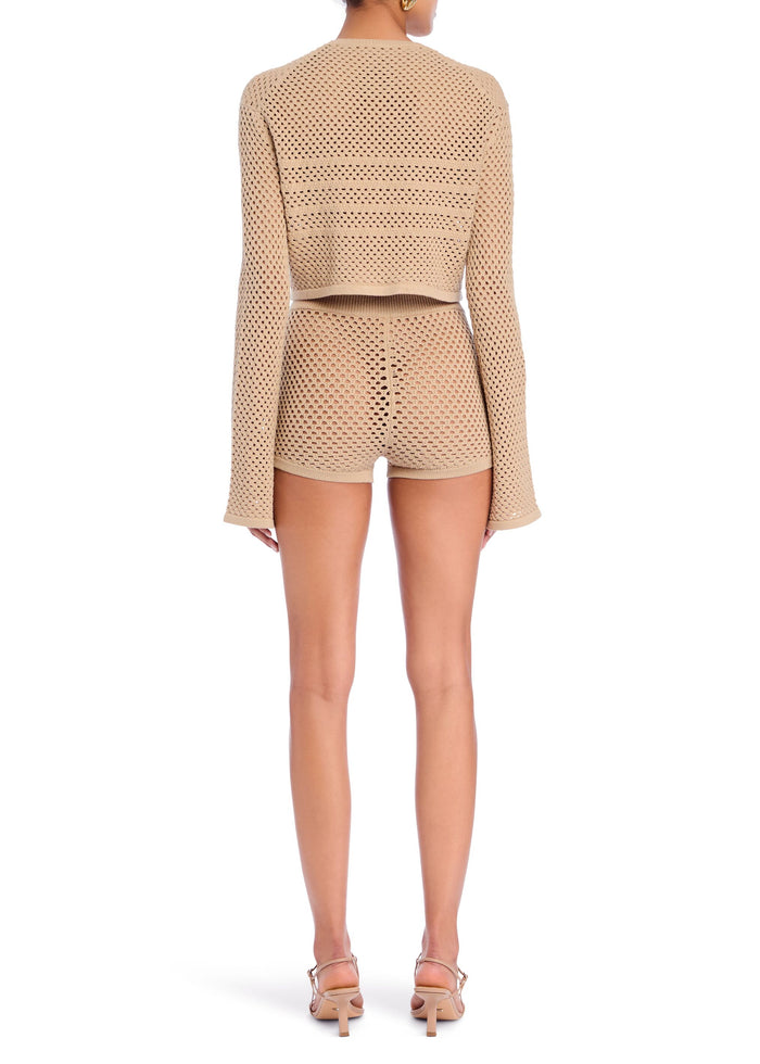 Back view of a model wearing a beige perforated knit cropped top and matching shorts media 3 of 5