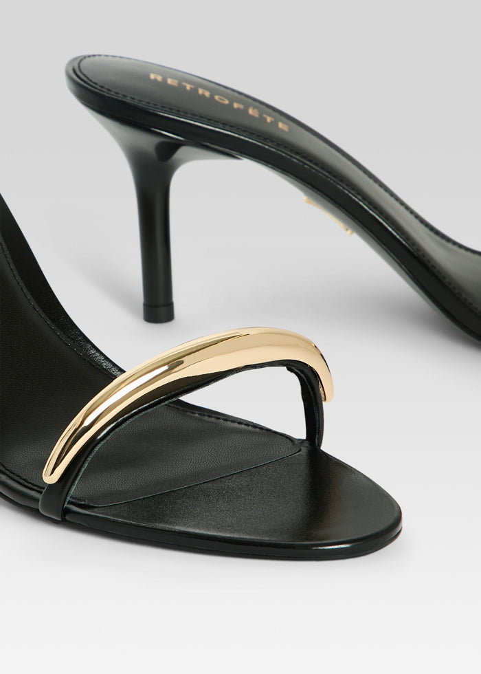 Karli Sandal close-up of black leather heel and gold curved strap on the toe area media 3 of 5