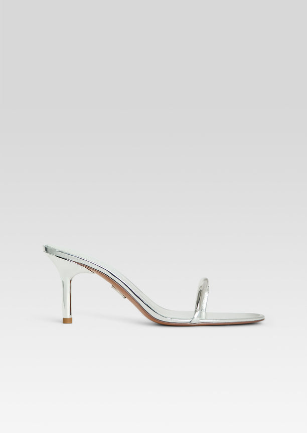 Silver metallic Karli sandal with a slim strap and curved mid heel in profile