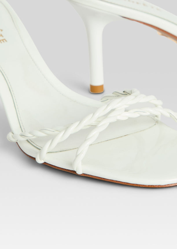 Close-up of white braided toe straps on the Karolina Sandal with a slim heel