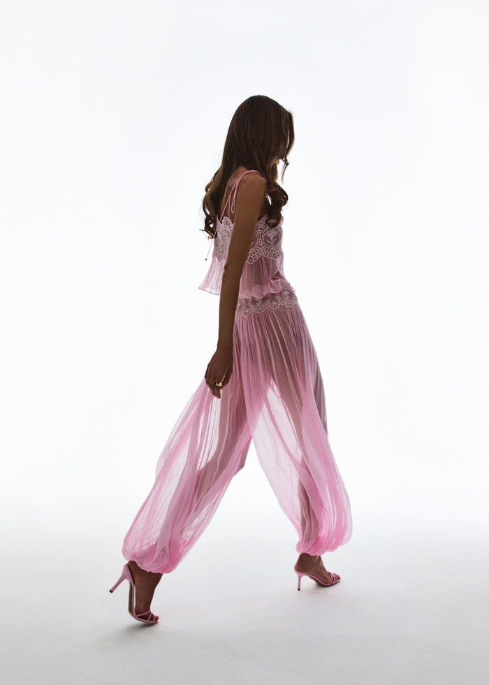 Full-length side view of a model in pink Dreamy Chiffon Pant with a lace top and pink heels. media 2 of 6