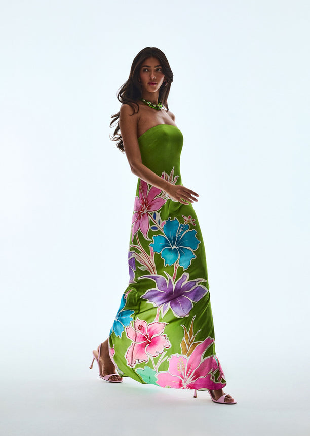 Full length view of a model wearing the Vivi Silk Dress in lime green with a bold tropical floral print.
