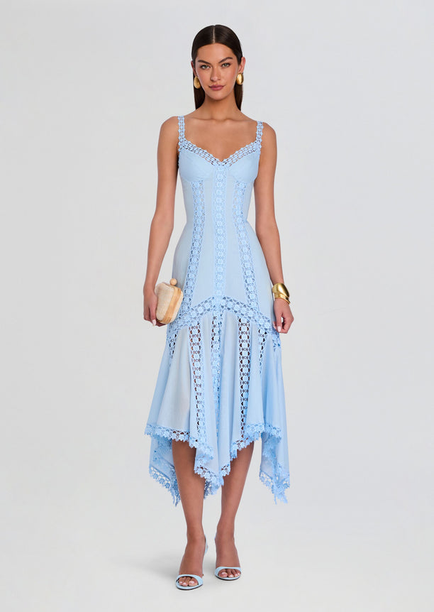 Blossel Long Dress in pale blue with vertical lace panels and scalloped lace hem, model holding a small clutch.