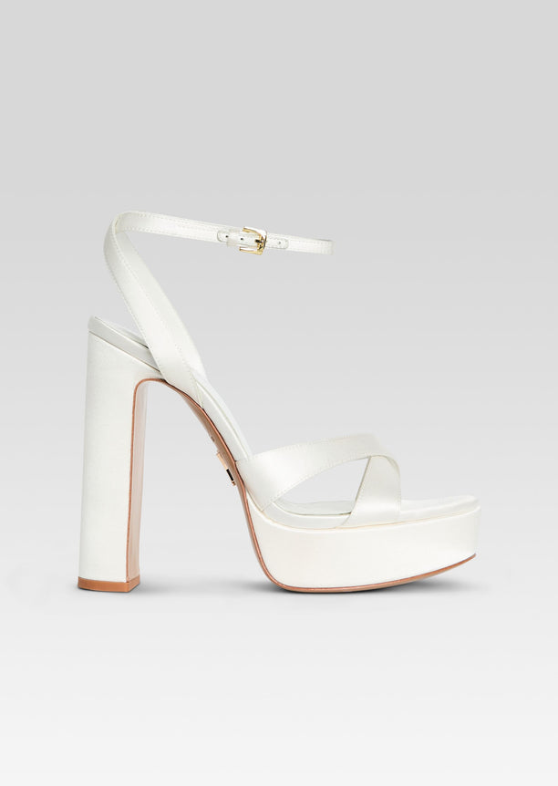 White Melodia Platform Sandal in side view with crisscross front straps and ankle strap