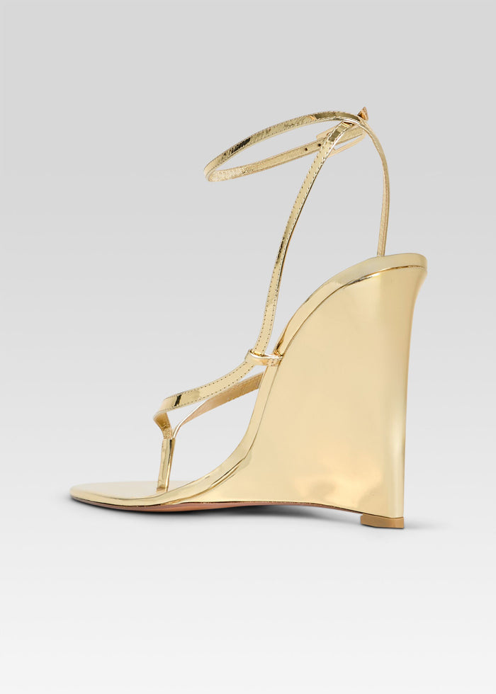 Gold metallic wedge sandal with delicate ankle wrap straps media 5 of 5