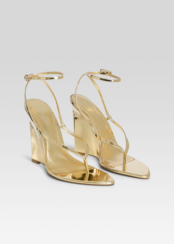 Namby Wedge pair of gold sandals with slender straps displayed on a light backdrop media 4 of 5