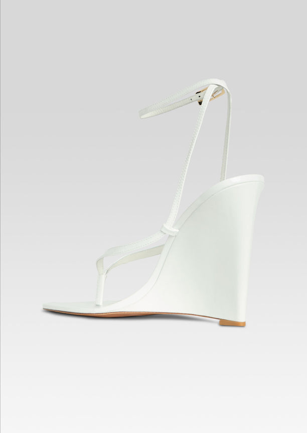 Namby Wedge white sandal side view with slim straps and ankle buckle