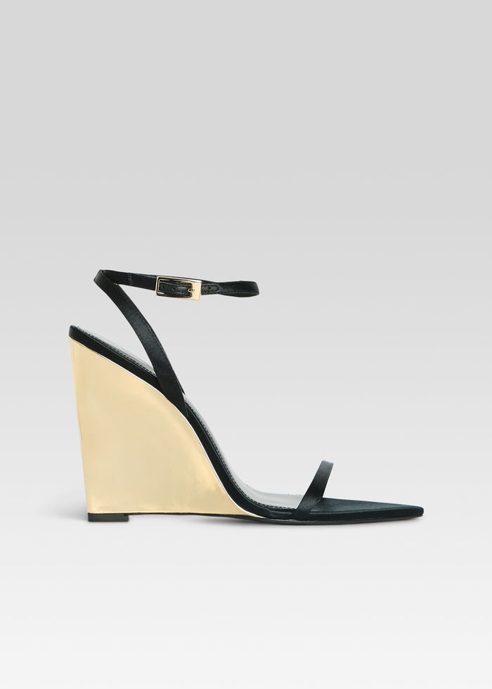 Black strappy wedge sandal with a gold wedge heel and ankle buckle media 1 of 5