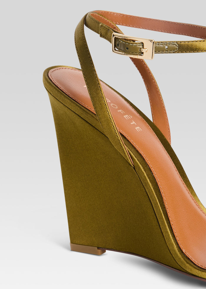 Close-up of olive wedge sandal showing the slender ankle strap with gold buckle and pink insole. media 3 of 5