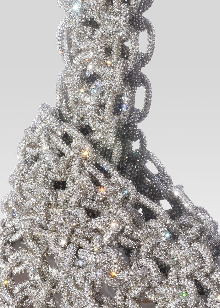 Niky Bag close up of a densely jeweled silver handbag covered in sparkling rhinestones with chain like texture media 3 of 4