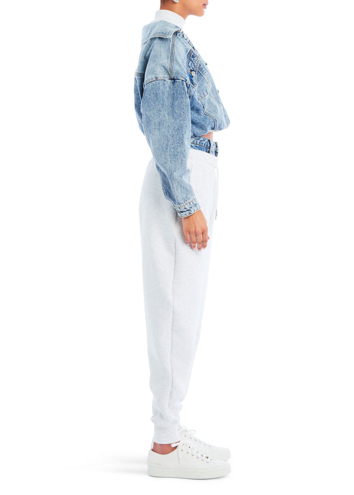Side profile of model wearing blue Caroline Jacket with light gray joggers and white sneakers media 3 of 4