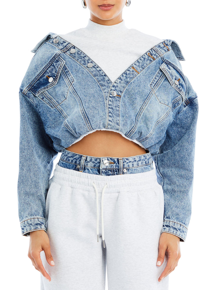 Cropped light wash Caroline Jacket worn off the shoulders over a white turtleneck media 1 of 4