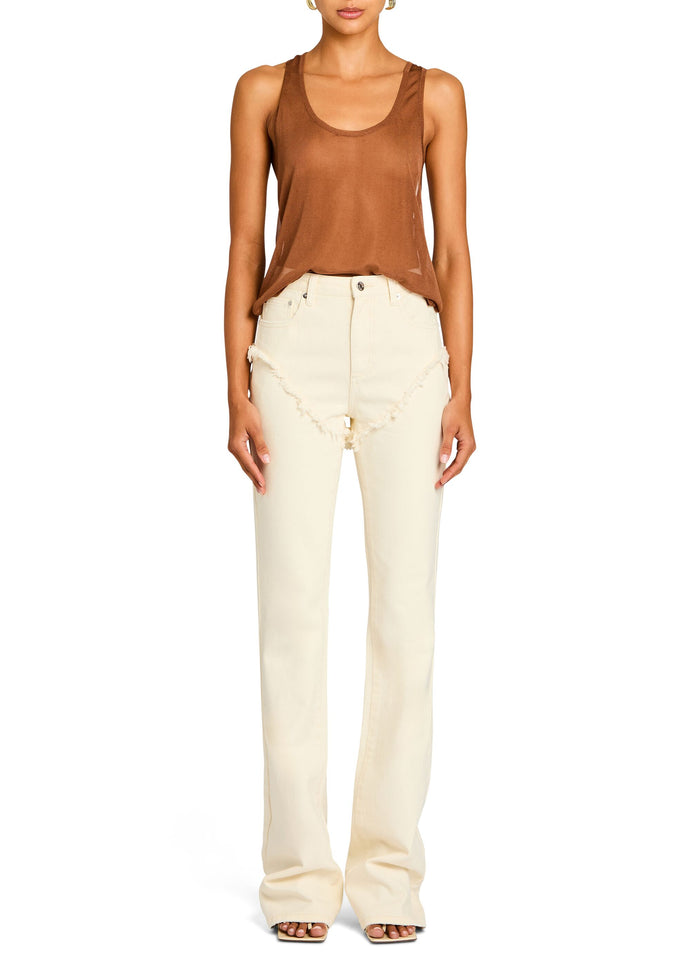 Front view of a model in a rust Arianna Knit Top tucked into cream high-waisted pants. media 5 of 5