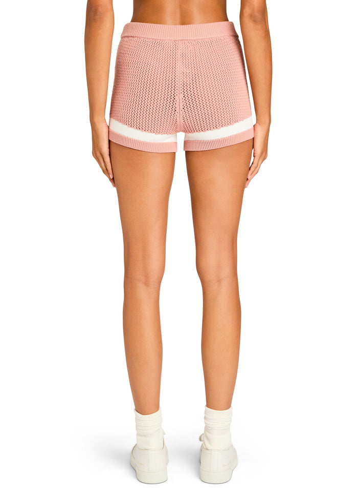 Back view of pink crochet knit short with a white stripe at the leg openings. media 3 of 4