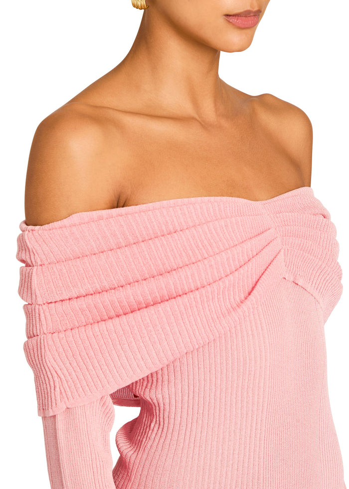 Close up of pink knit fabric showing the off the shoulder neckline and chunky ribbing. media 2 of 5