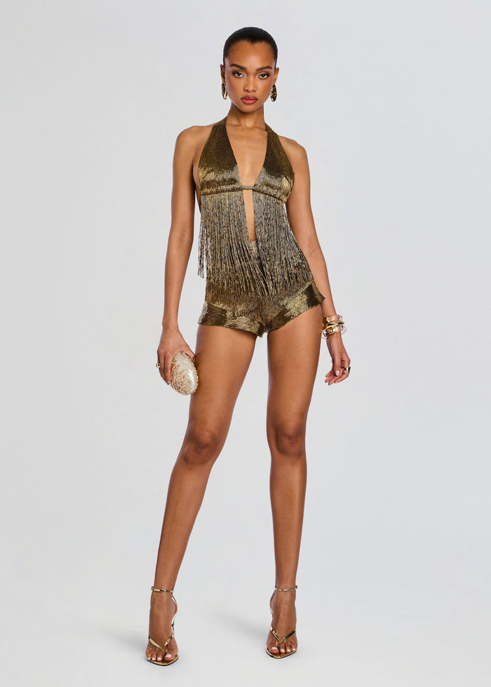 Model wearing a gold fringe halter top with mustard shorts and strappy sandals. media 2 of 6