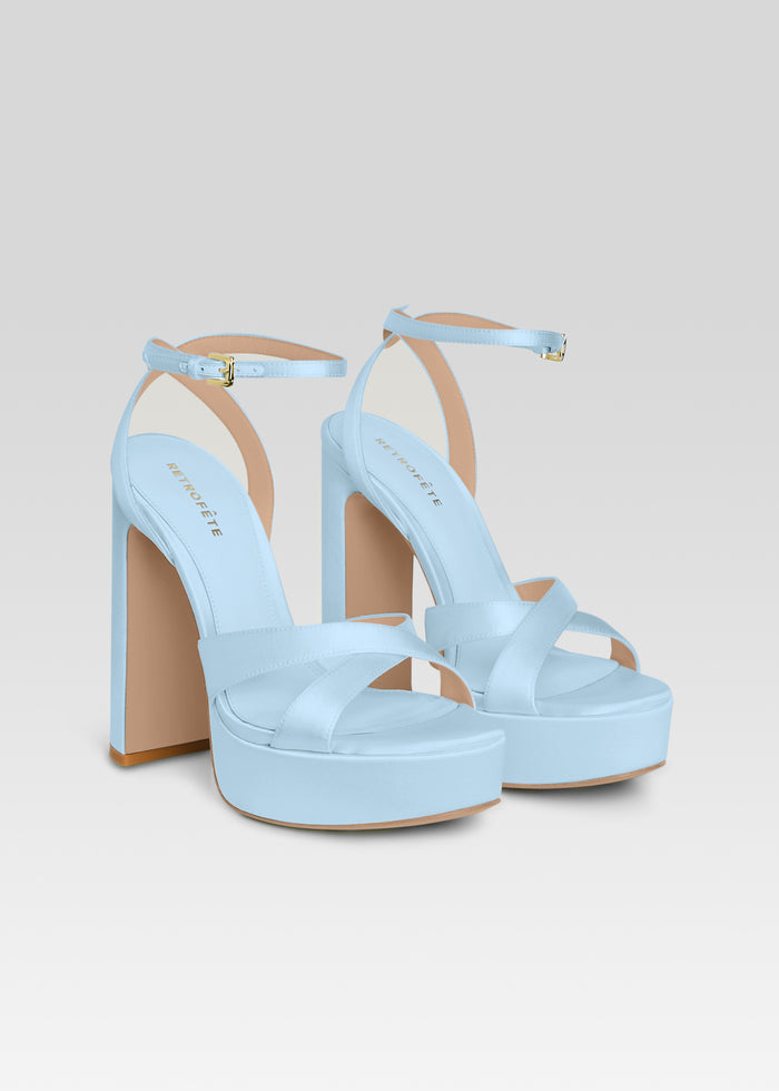 Pair of light blue Melodia platform sandals with crisscross front straps and buckle ankle straps. media 4 of 5
