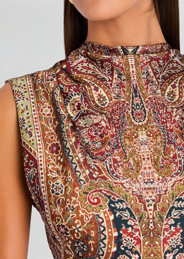 Close-up of the paisley patterned fabric from the Ruza mini dress showing intricate burgundy gold and cream details.