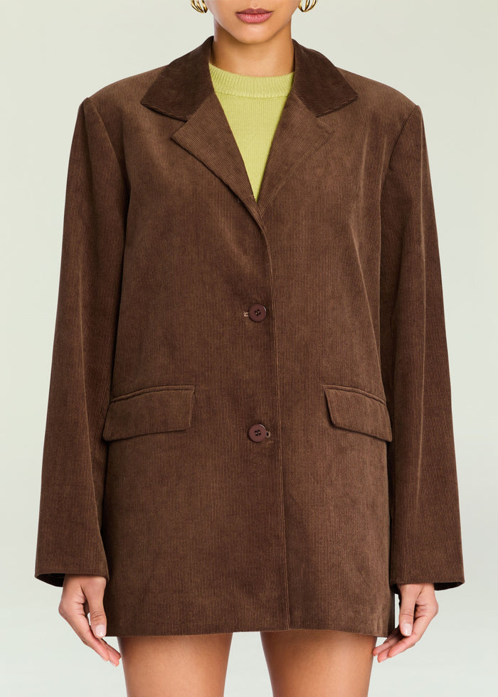 Brown corduroy Hera Blazer with notched collar and two buttons worn over a lime knit top media 1 of 5