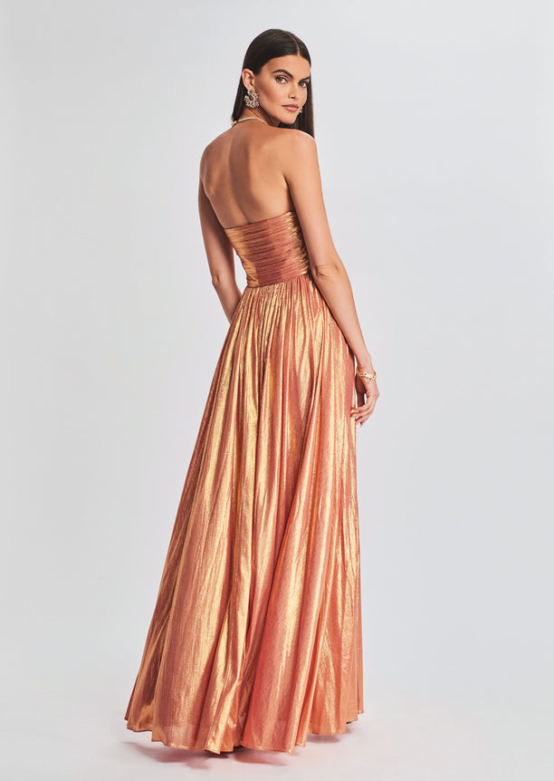 Back view of a strapless metallic copper Waldorf Dress with a ruched bodice and flowing skirt.