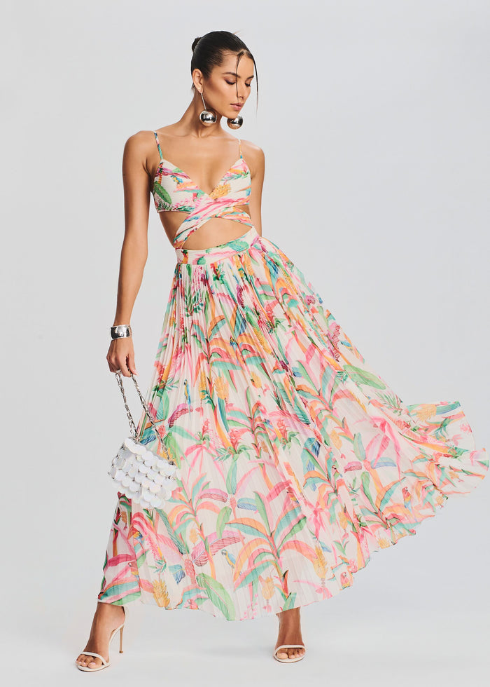 Model wearing the tropical Rio Long Dress a colorful maxi with a wrapped bodice and a full pleated skirt. media 1 of 5
