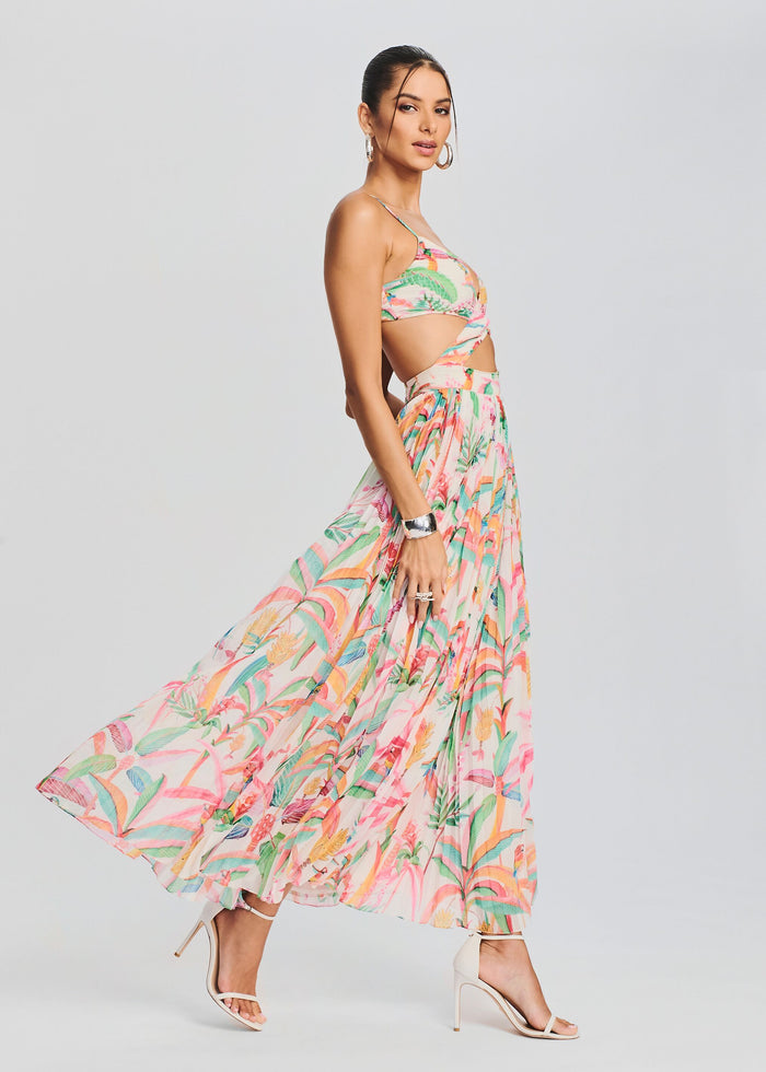 Rio Long Dress tropical print maxi shown from the side with twisted bodice, waist cutouts, and a flowing skirt. media 3 of 5